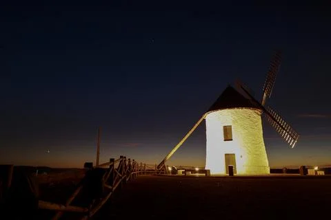 Windmill at sunset in Cerro de San Juan hill in Pozo Canada town, Castilla .. Stock Photos