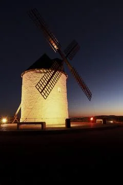 Windmill at sunset in Cerro de San Juan hill in Pozo Canada town, Castilla .. Stock Photos