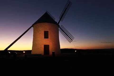 Windmill at sunset in Cerro de San Juan hill in Pozo Canada town, Castilla .. Stock Photos