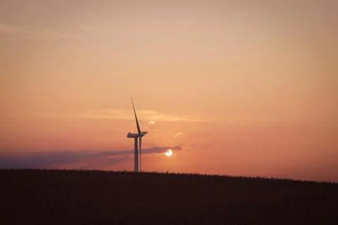 Windmill in the sunset on a hill Stock Photos