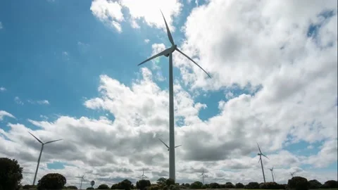 Windmill time lapse in foreground generating alternative and green energy in Stock Footage 150782983