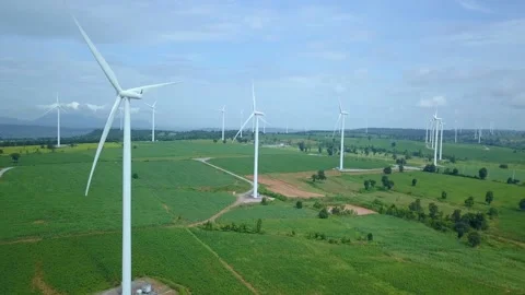 A windmill on top of a green field 库存影片 156845400
