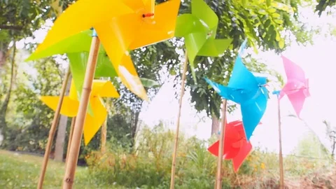 Windmill toy spinning with tree background Stock Footage 107817349