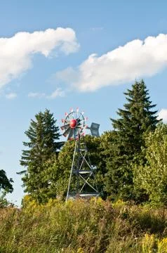 Windmill with Trees and Blue Sky Stock Photos