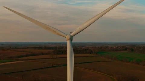 Windmill turbine rotating to generate alternative electricity over rural Stock Footage 311527124