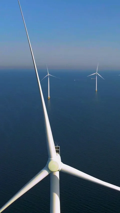 Windmill turbines with a blue sky, windmill in the ocean aerial view from drone Stock Footage 229255969