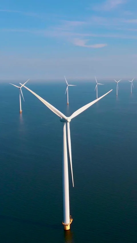 Windmill turbines with a blue sky, windmill park in the ocean aerial view from Stock Footage 229256068