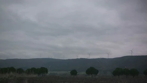 Windmill Turning -  Wind Turbine Wide Shot - Cloudy Day Stock Footage
