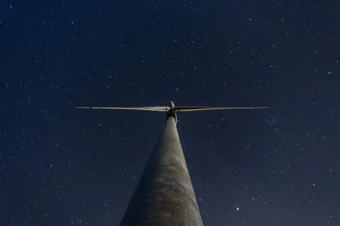 Windmill under the starry sky at night Stock Photos