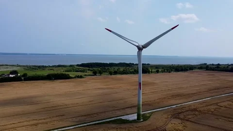 A windmill in a wheat field, a drone flying around Stock Footage 180043802