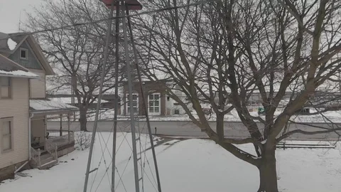 Windmill - wind power by a house - self sufficient farm.  Stock Footage 124939139