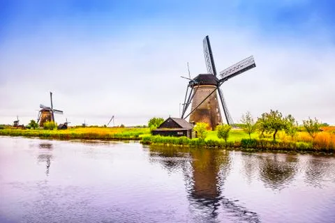 Windmills and canal in Kinderdijk, Holland or Netherlands. Unesco site Stock Photos