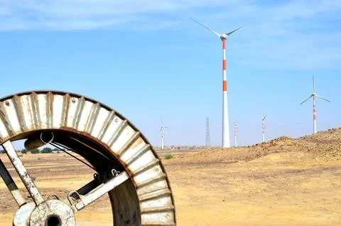 Windmills in the backdrop of a winding wheel on the way to Sam Sand Dunes 写真素材