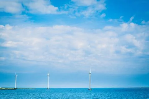 Windmills in the blue ocean Stock Photos