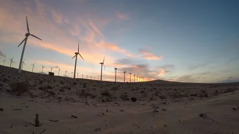 Windmills in a desert during sunset Stock Footage 120504492