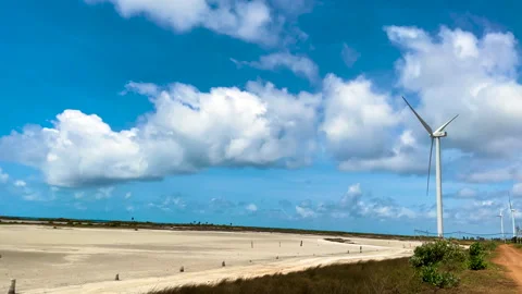 Windmills on a desolate sand plain with strong winds under a bright sky. Stock-Footage 289890734