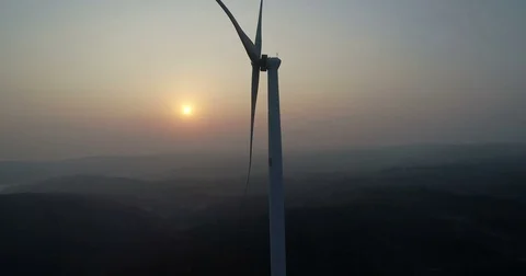 Windmills for electric power on sunset background Stock Footage 83243073