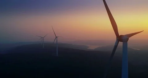 Windmills for electric power on sunset background Stock Footage 83315624