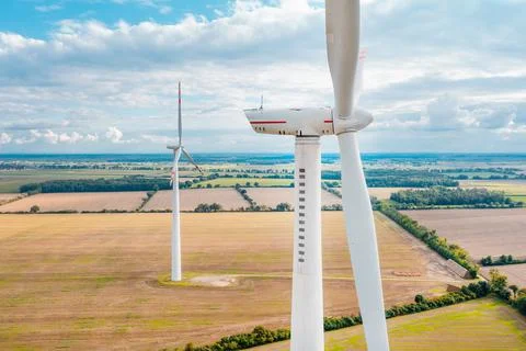 Windmills generate electricity in the fields. Alternative sources of energy,  Stock Photos