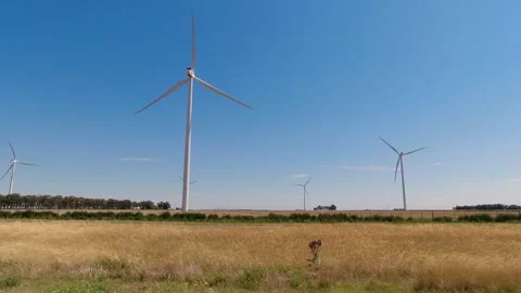 Windmills generating electrical energy. Blue sky with clouds. Stock Footage 296605951