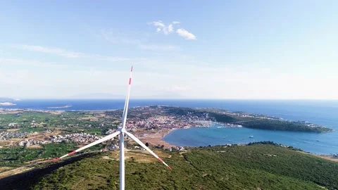 Windmills generating electricity in the forest area accompanied by a sea view Stock Footage 236446523