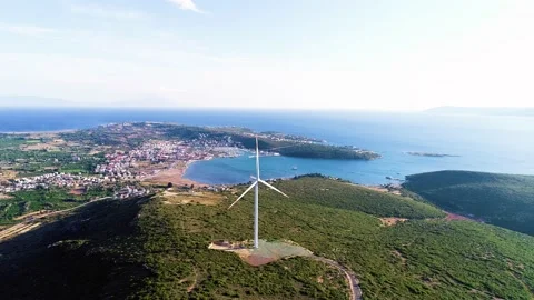 Windmills generating electricity in the forest area accompanied by a sea view Stock Footage 236446659