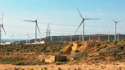 Windmills for generating electricity, rolling hills in the background. The Stock Footage 120977846