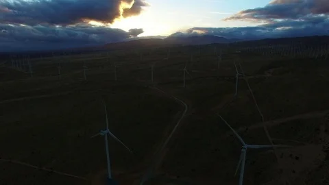 Windmills generating energy while the sun is slowly getting up Stock Footage 79164908