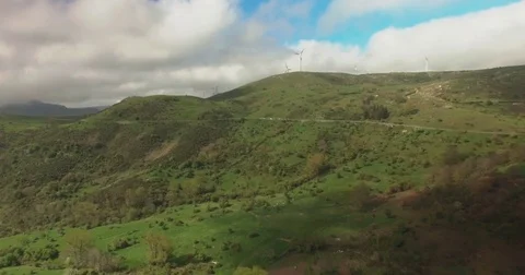 Windmills on green hills Stock Footage 77080847