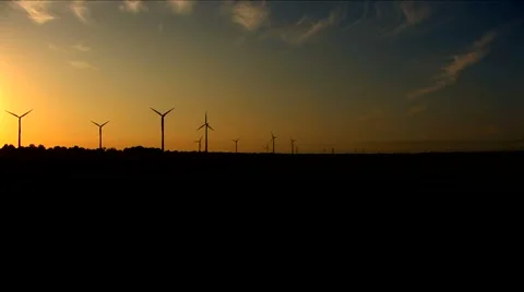 Windmills on the horizon during sunset - loop Stock Footage 5700922