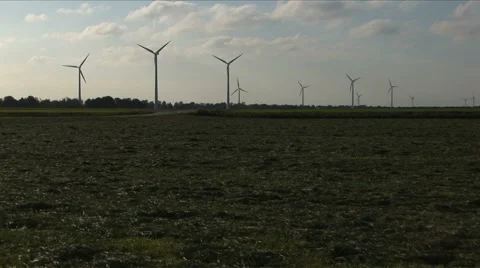 Windmills on the horizon of a field Stock Footage 5700916