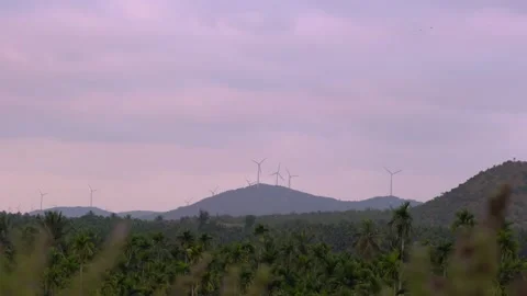 Windmills on a mountain range, handheld shot at sunset 動画素材 151713188