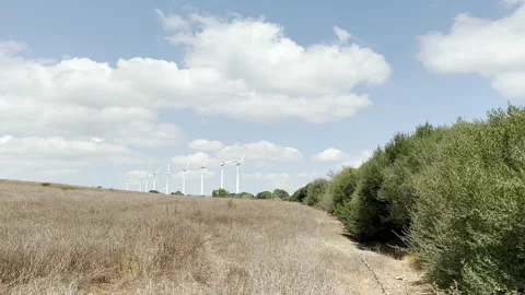 Windmills moving with the wind to generate clean energy Video stock 206399202