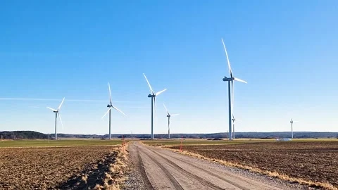 Windmills on an open farm field. View from a gravel road. Stock Footage 267113151