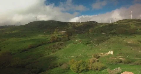 Windmills over green fields Stock Footage 77058271