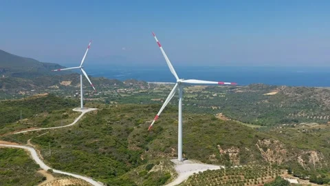 Windmills producing renewable energy from wind Видео 253750819