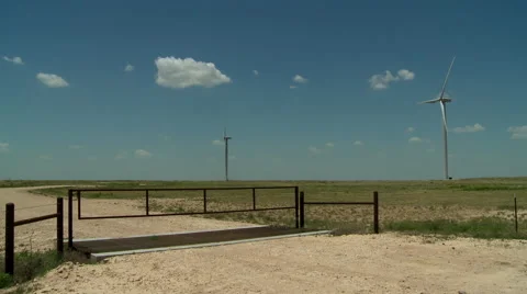 Windmills on ranch with cattle gate in Oklahoma panhandle Stock Footage 40449345