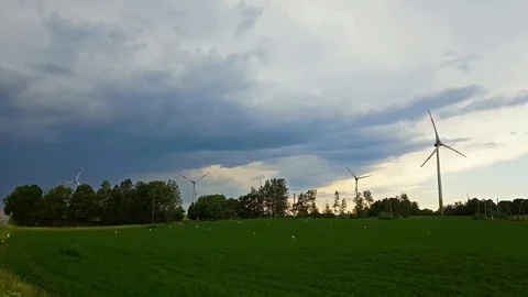 Windmills rotate blades over fields, Lithuania Stock Footage 91150154
