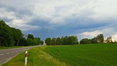Windmills rotate blades over fields, Lithuania Video stock 91150456