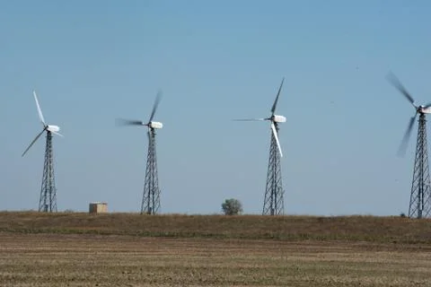 Windmills rotating on field Stock Photos