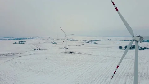Windmills rotating by the force of wind and generating renewable energy in cold 스톡 동영상 232384165