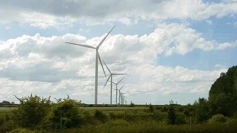 Windmills In a Row Being Passed and Filmed From a Bus Vidéo 120644894