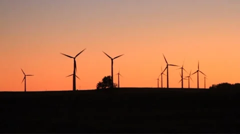 Windmills spin at dusk Stock Footage 8775654