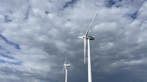 Windmills spinning against cloudy sky Stock Footage 242072426