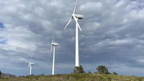 Windmills spinning against cloudy sky Stock Footage 242072449