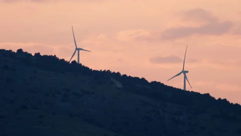 Windmills at sunset in the mountains. Sources of clean electricity. Stock Footage 201630659