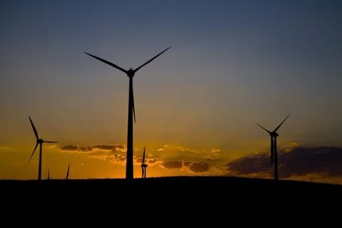 Windmills at sunset Stock Photos