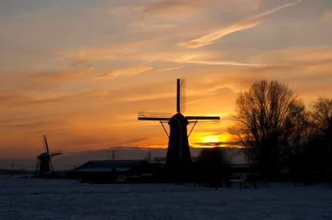 Windmills at sunset Stock Photos