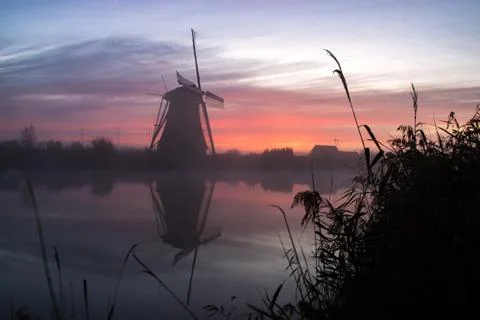 Windmills at sunset Stock Photos