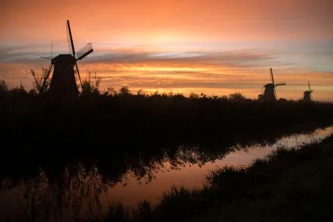 Windmills at sunset Stock Photos